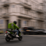 courier riding scooter